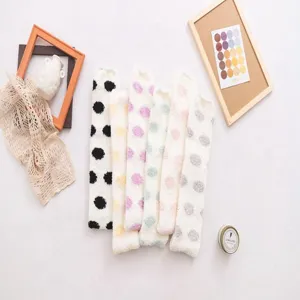 Cozy over-the-knee coral fleece fuzzy stockings for women, cute polka dot winter warm thigh-high socks.