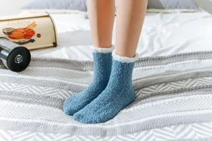 Detail view of thick cozy coral fleece winter floor socks for women in solid blue.