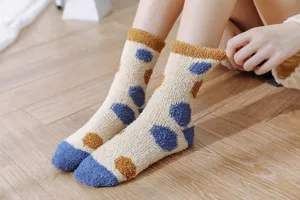 Cozy coral fleece plush socks detail view, featuring cute paw print pattern for winter home wear.