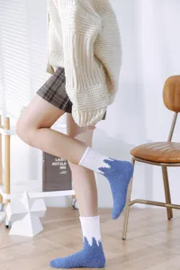 Cozy blue and white coral fleece winter socks detail, showing thick warm fleece texture.