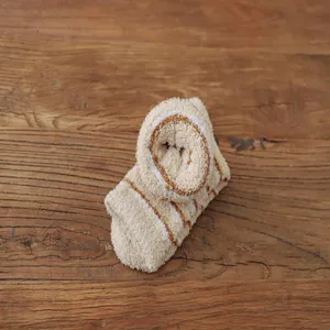 Cozy coral fleece sock detail, soft texture and warm stripe design for winter home comfort.