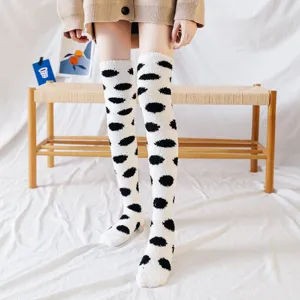 Cozy over-the-knee coral fleece socks for women, cute polka dot design for winter home wear.