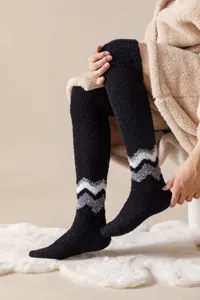 Cozy black fuzzy over-the-knee long socks with chic chevron pattern for winter warmth.