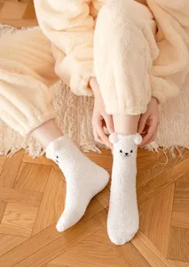 Cozy winter thick fleece fuzzy socks with cute bear ears and embroidered face for warm home wear.