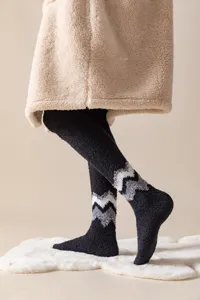 Close-up detail of men's thick fleece over-the-knee warm socks with cozy zig-zag pattern.