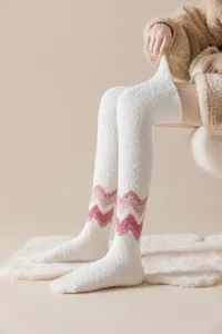 Detailed view of women's fuzzy over-the-knee winter socks with cute pink zig-zag pattern.