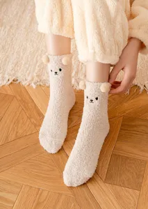 Close-up of fluffy bear ears fleece socks, cozy winter design with cute embroidered face details.