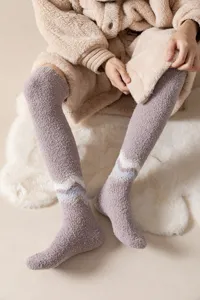 Cozy fleece over-the-knee socks for winter home comfort, soft warm fluffy sleep stocking detail.