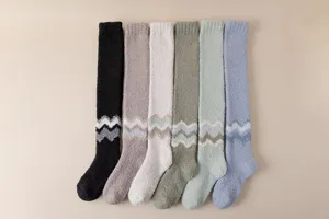 Detailed view of winter over-the-knee fuzzy coral fleece socks with chevron pattern in multi colors.