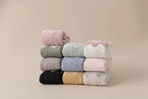 Detailed view of cozy fuzzy socks, soft coral fleece texture, warm winter home socks.