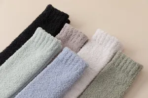 Detailed close-up showing soft fluffy coral fleece texture and cozy multi-color warm sleep socks.