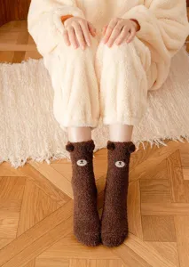 Close-up of brown plush bear mid-tube socks featuring cute 3D ears and embroidered face.