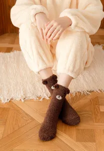Detailed shot of cute brown fluffy bear socks featuring plush 3D ears and sweet embroidered face.