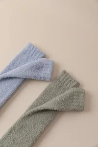 Cozy coral fleece long socks for women, thick and warm winter fuzzy knee-high stockings.