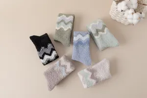 Cozy coral fleece fuzzy winter socks detail showing soft chevron patterns and thick warm texture.