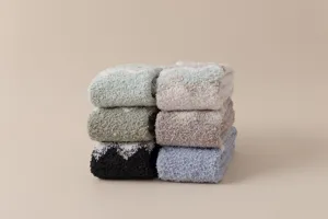 Cozy winter fuzzy coral fleece socks stack, soft plush sleep floor socks for home use.