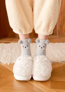 Detailed closeup of cute fuzzy plush mid-calf socks with bear design worn indoors.