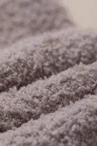 Close up of soft grey coral fleece fabric texture, detailed winter warm fuzzy plush material view