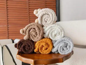 Cozy winter thick plush coral fleece socks with cute pom poms for warm home floor sleeping.