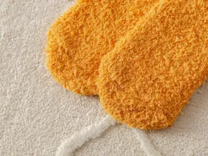 Close up of soft yellow fluffy fuzzy winter home floor socks detail texture fleece cozy warm