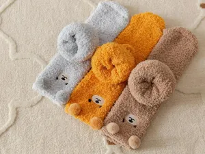 Cozy coral fleece winter socks detail, cute bear design with fuzzy ears, soft floor socks.