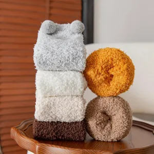 Cozy coral fleece fuzzy socks detail showing soft texture and cute rolled design for winter.