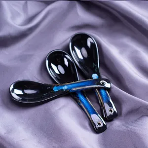 Creative ceramic soup spoon with blue glaze, long handle design for home kitchen, detail view.