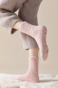 Plush fuzzy coral fleece socks detail view, soft cozy anti-slip silicone sole design.
