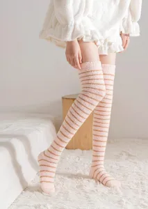 Cozy fleece over-the-knee winter socks detail shot, soft striped thermal loungewear hosiery.