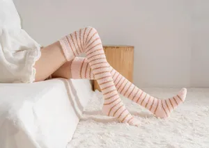 Cozy coral fleece over-the-knee striped socks for women, thick warm winter home wear detail.