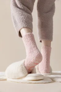 Thickened coral fleece cozy socks with anti-slip silicone soles for indoor warm winter wear.