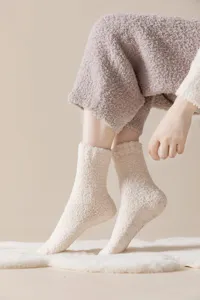 Detailed view of cozy fuzzy thick plush socks with anti-slip silicone grips for warm indoor wear.