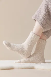 Closeup of cozy thickened coral fleece sleeping socks with anti-slip silicone dots on sole.