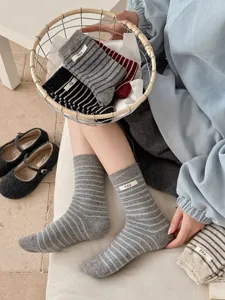 Detail view of Korean style striped wool blend socks for women with cute egg label warm winter.
