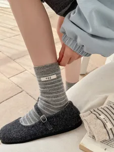 Korean style striped wool socks detail view, cozy winter mid tube knit socks with cute label.
