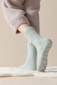 Detailed close-up of thick plush cozy fuzzy winter floor socks with anti-slip grip soles.