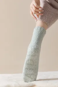 Close-up detail shot of plush fuzzy thermal floor socks featuring silicone anti-slip grip sole.