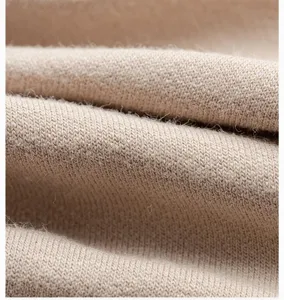 Close-up detail shot of breathable knit fabric texture showing fine weave and soft material.