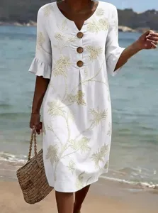 Beachwear style detail shot, white linen dress with floral embroidery and wooden buttons.