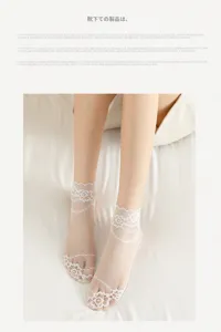 Detail view of sheer white lace ankle socks, breathable mesh summer short socks close-up.