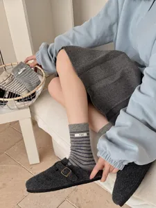 Detailed close-up shot of stylish Korean design striped wool crew socks with an egg label.