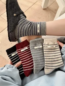 Detailed view of women's striped wool socks with egg label, warm cashmere winter socks.