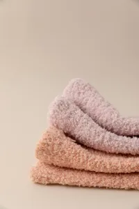 Thickened coral fleece women warm mid-tube solid color sleeping floor socks detail.