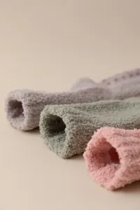 Close-up of cozy coral fleece fuzzy socks with anti-skid silicone dots for warmth.