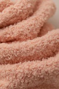 Soft coral fleece fabric close-up detail, thick warm solid color cozy winter socks material.