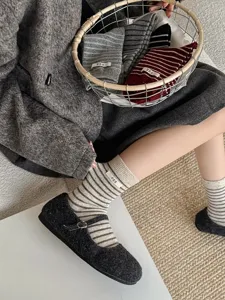 Korean style striped mid-tube wool socks with cute fabric label, cozy warm daily wear detail.