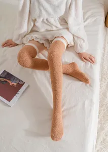 Cozy fuzzy over-the-knee socks for women, thick coral fleece winter sleep and home wear.