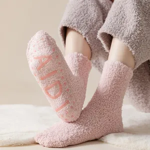 Thick coral fleece fuzzy socks for women, cozy winter warm anti-slip floor socks in pink.
