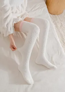 Cozy coral fleece over-the-knee winter socks with pink stripes, warm and soft home wear.