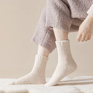 Thickened coral fleece women's mid-tube warm sleep socks with anti-slip silicone soles.